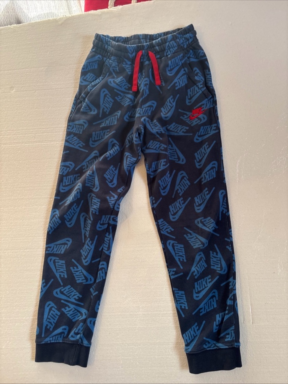 Nike Blue All-Over Logo Joggers with Red Drawstring